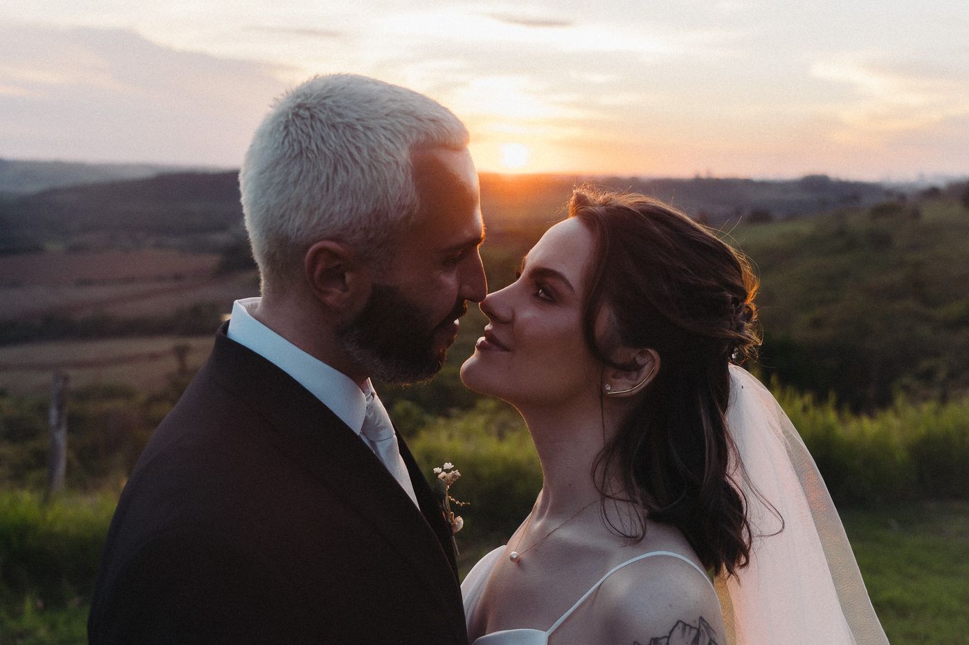 Casal ao pôr do sol no campo